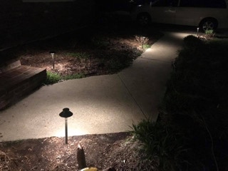 Walk way lit at night by Dependable Landscaping