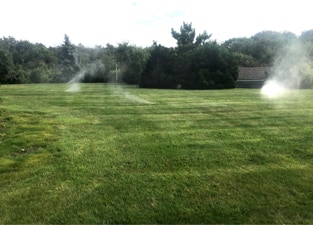 green lawn being watered