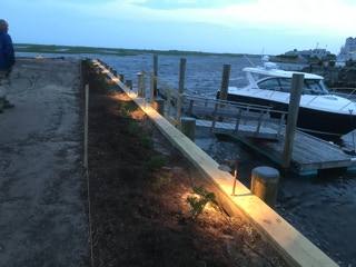 Dock, lit at night by Dependable Landscaping